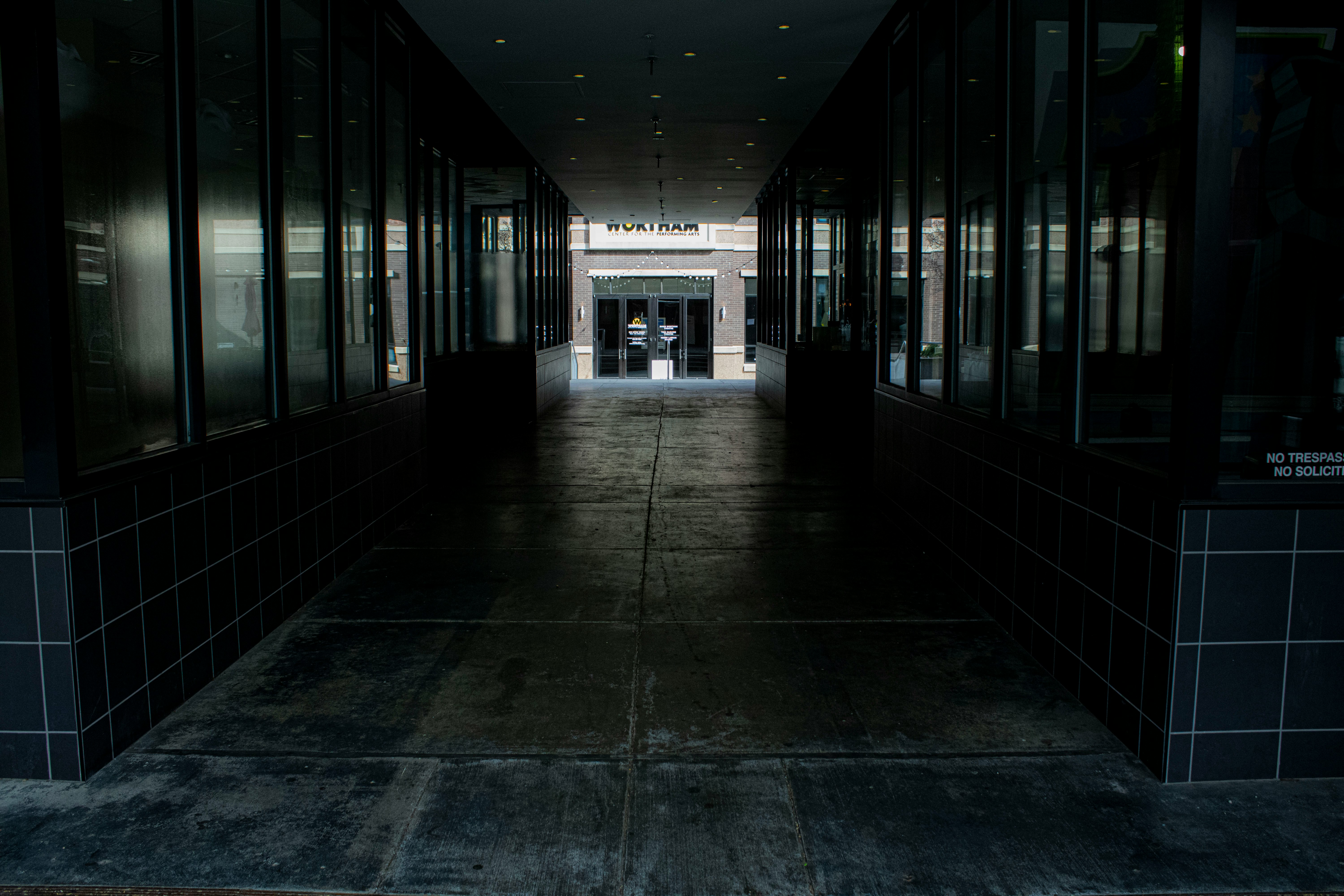 a dark hallway with a clock on the wall