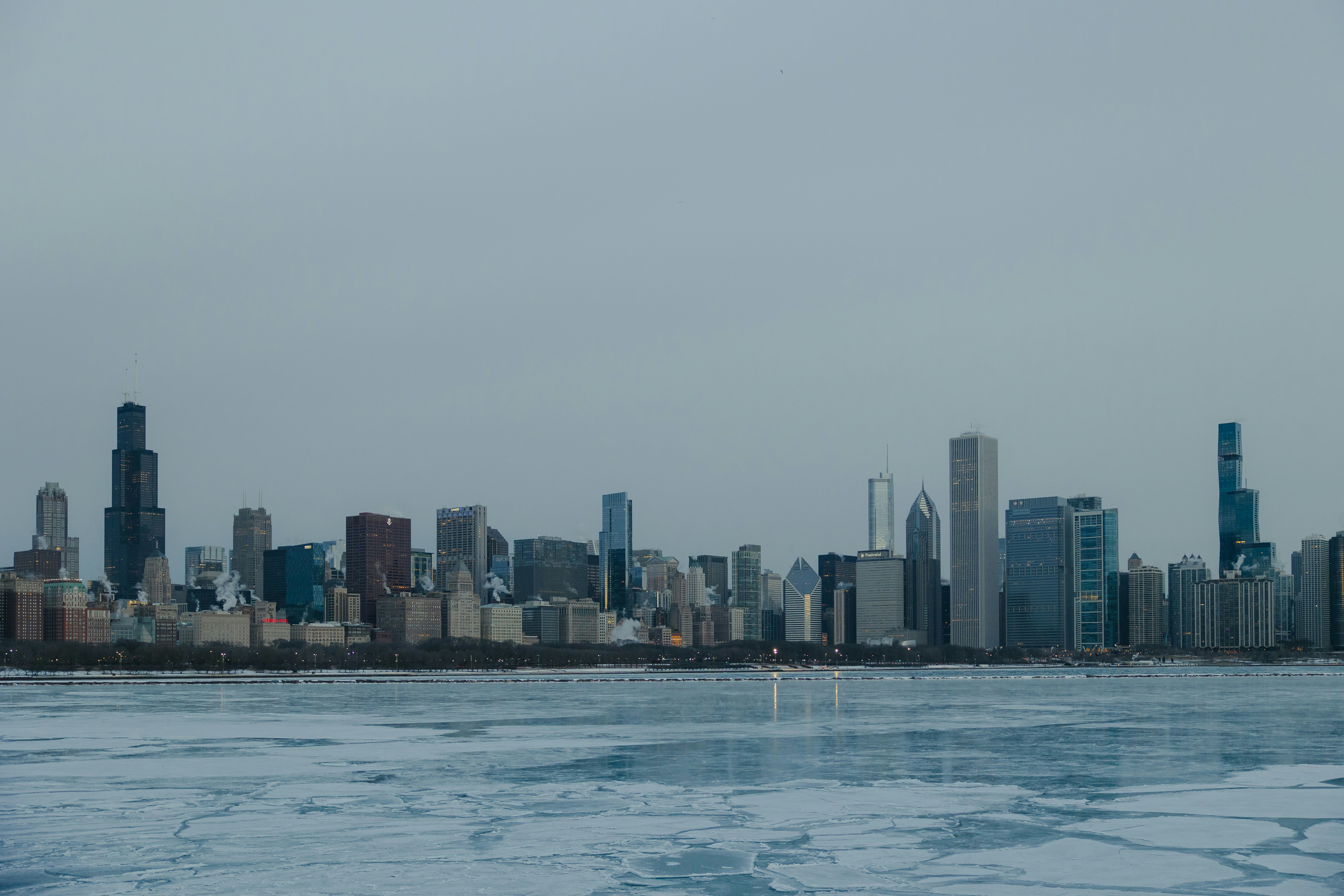 City skyline across a frozen lake on a cloudy day